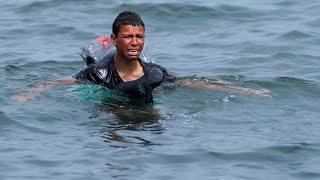 Ceuta Migrant boy swims to shore with plastic bottles tied to himself [upl. by Abram491]